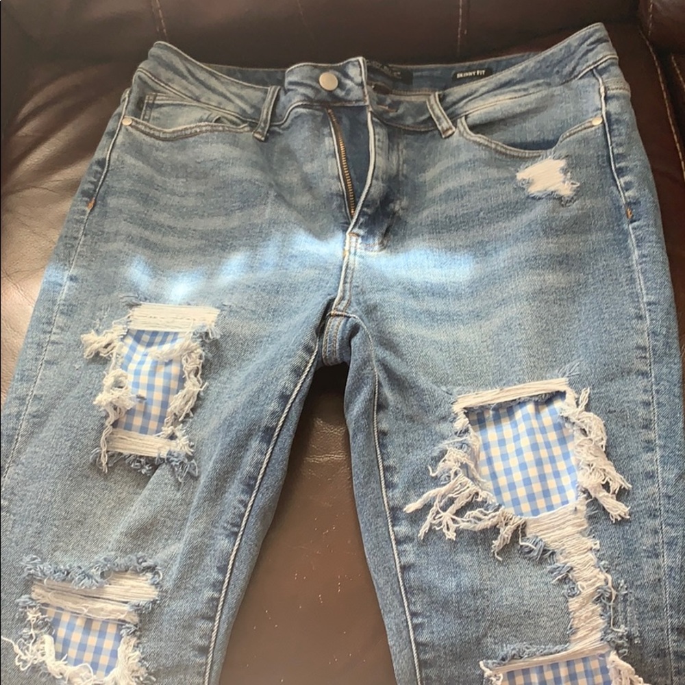 Judy blue distressed jeans with gingham backing.